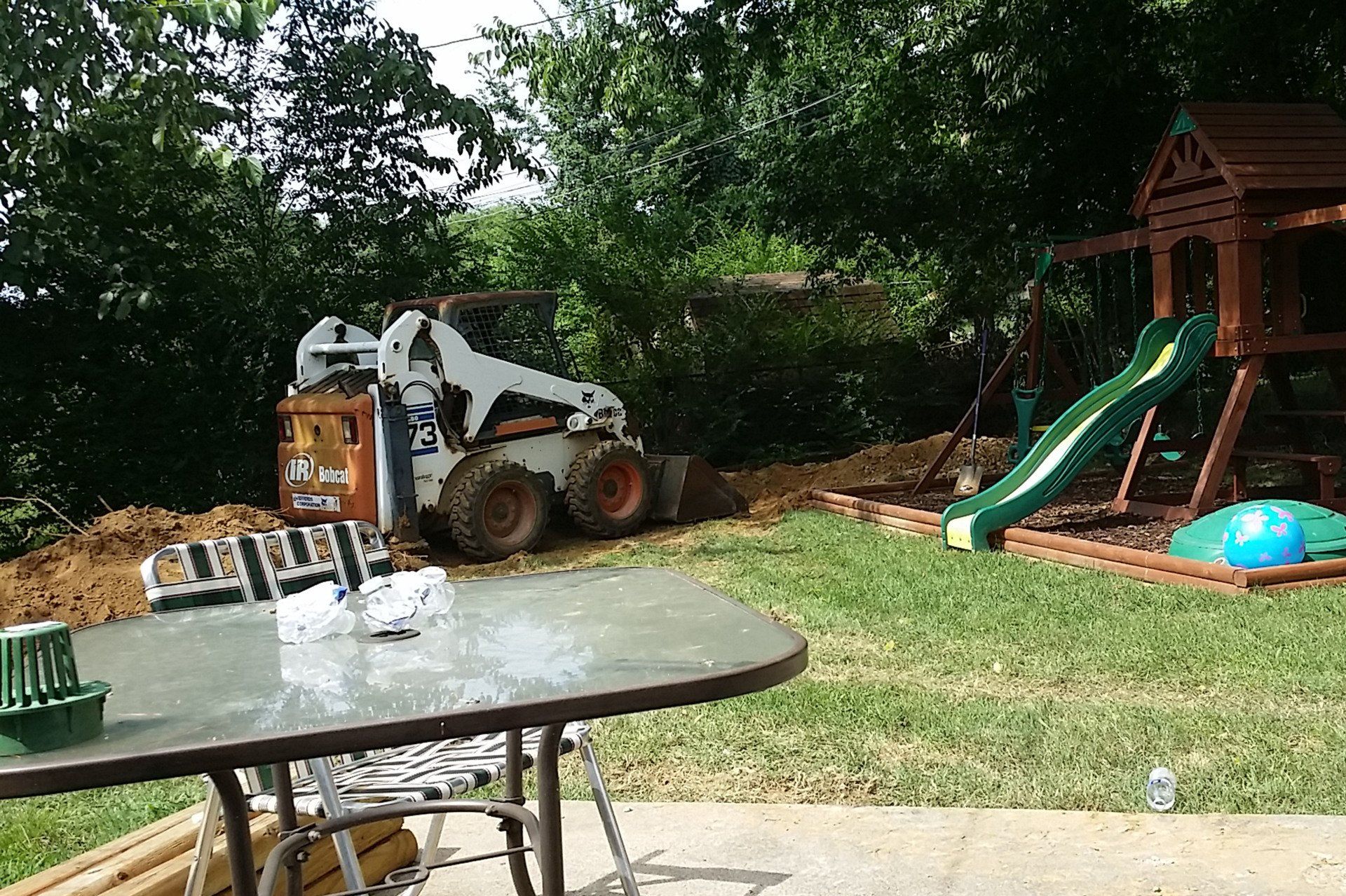 A Dozer Parked In Front Of A Playground — Clarksville, TN — Jim Davis & Son Plumbing JDS Mechanical Inc.